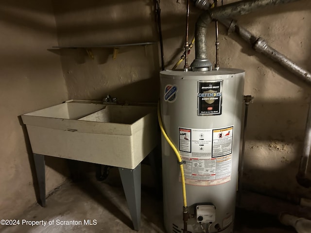 utility room with gas water heater and sink