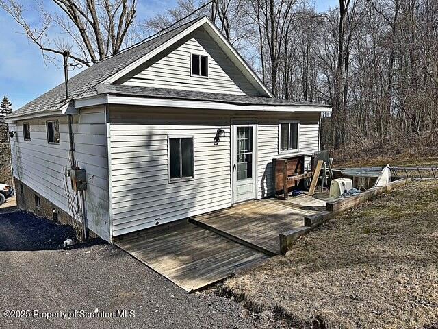 back of house with a deck