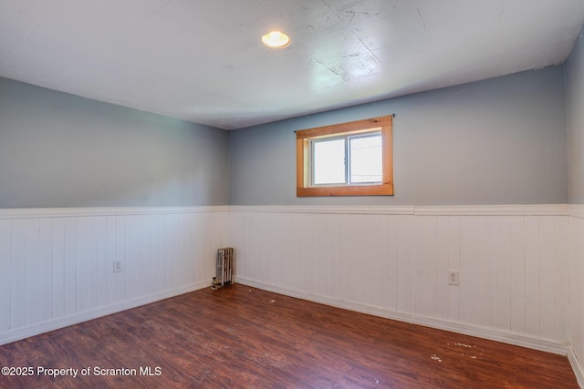 506 Short St, Throop, PA 18512 - unfurnished room with radiator, wood finished floors, and wainscoting