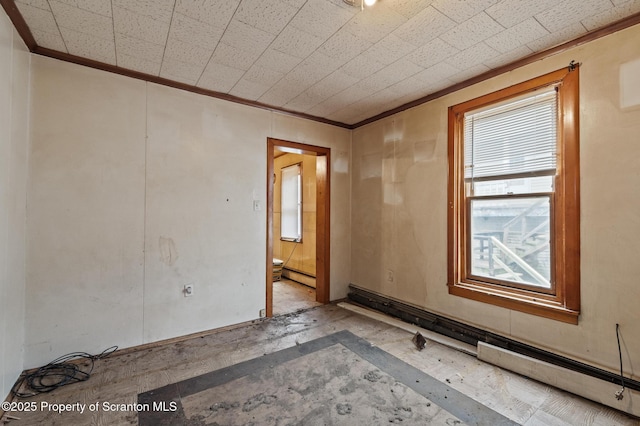 spare room with a baseboard heating unit and ornamental molding