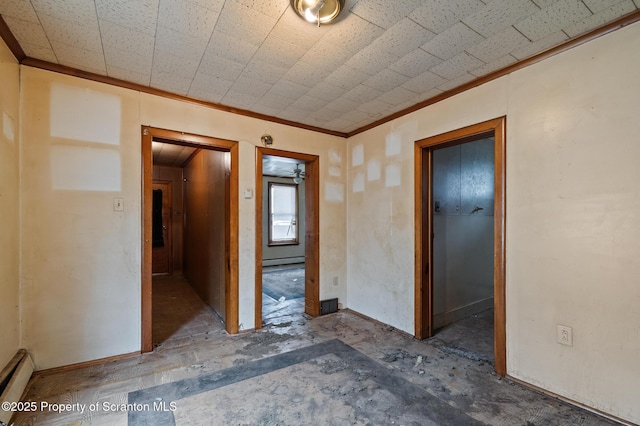 empty room featuring a baseboard radiator, baseboards, and crown molding
