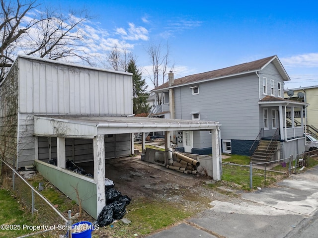 view of property exterior with a chimney and fence private yard