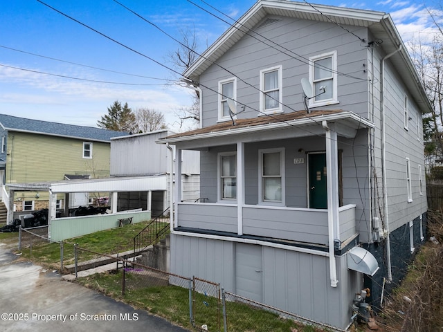 view of front of home with a porch and fence private yard