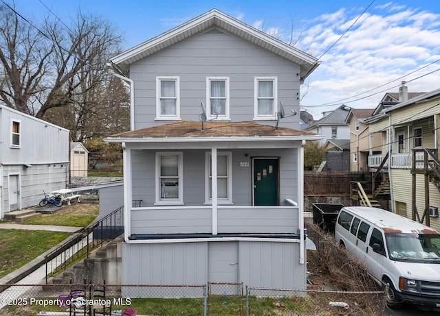traditional style home with a porch, stairs, and fence private yard