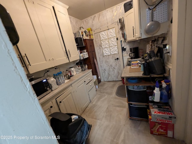 846 Capouse Ave, Scranton, PA 18509 - kitchen with stainless steel microwave, light countertops, and white cabinets