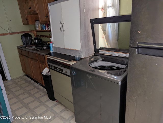 846 Capouse Ave, Scranton, PA 18509 - kitchen with freestanding refrigerator, light floors, brown cabinets, and a sink