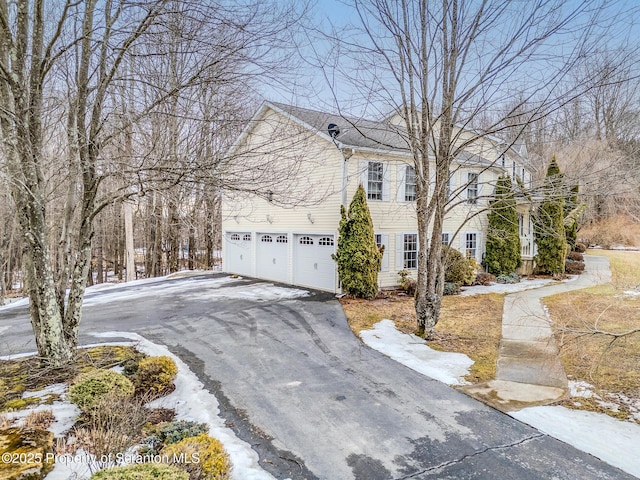 view of front of home with a garage and aphalt driveway