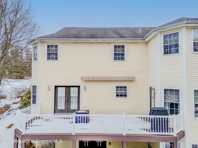 rear view of house with french doors and a deck