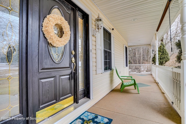 view of exterior entry with covered porch