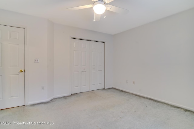 unfurnished bedroom featuring a ceiling fan, a closet, and baseboards