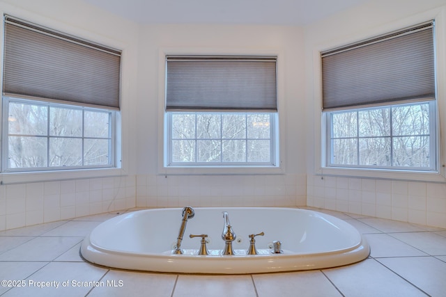 bathroom featuring a bath and a wealth of natural light