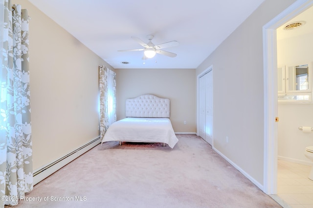 bedroom featuring a baseboard radiator, a closet, visible vents, ensuite bathroom, and baseboards