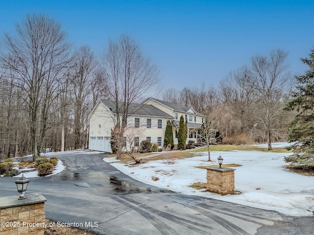 view of front of house featuring aphalt driveway and an attached garage