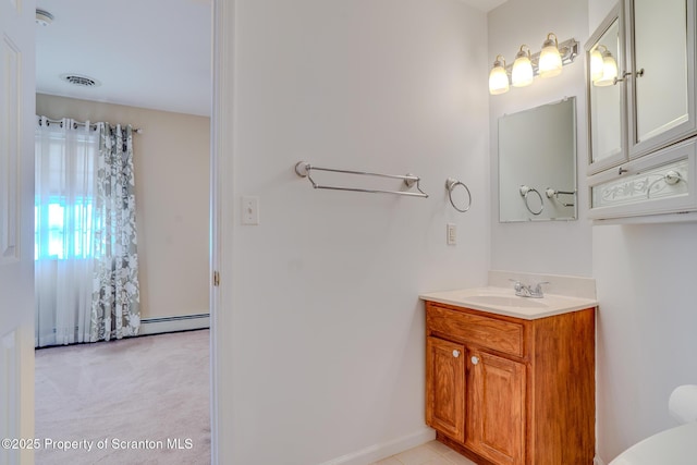 bathroom with a baseboard heating unit, visible vents, and vanity