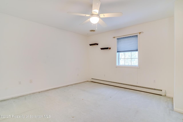 spare room with a baseboard heating unit, light colored carpet, baseboards, and a ceiling fan