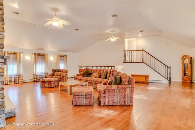 living area with a baseboard radiator, light wood-style flooring, stairs, and a ceiling fan