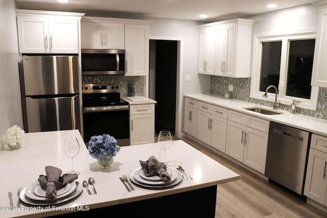 kitchen with white cabinetry, appliances with stainless steel finishes, and sink