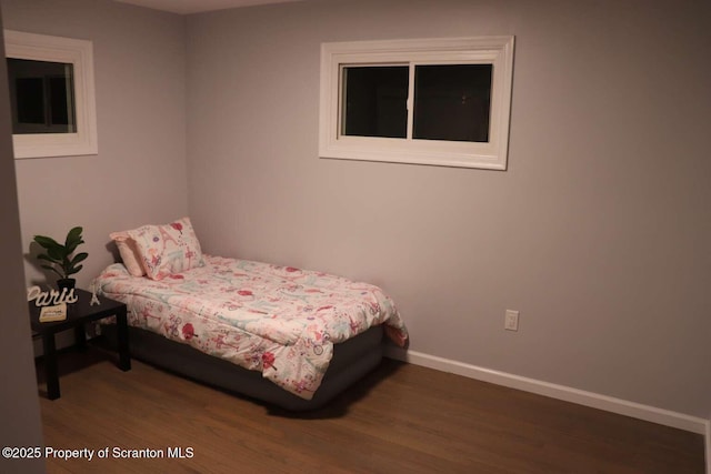 bedroom with dark hardwood / wood-style flooring