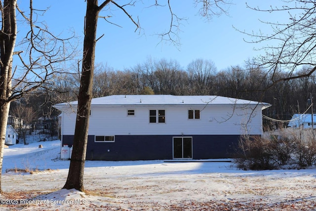 view of snow covered rear of property