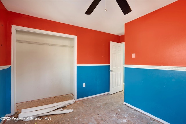 interior space featuring ceiling fan and a closet