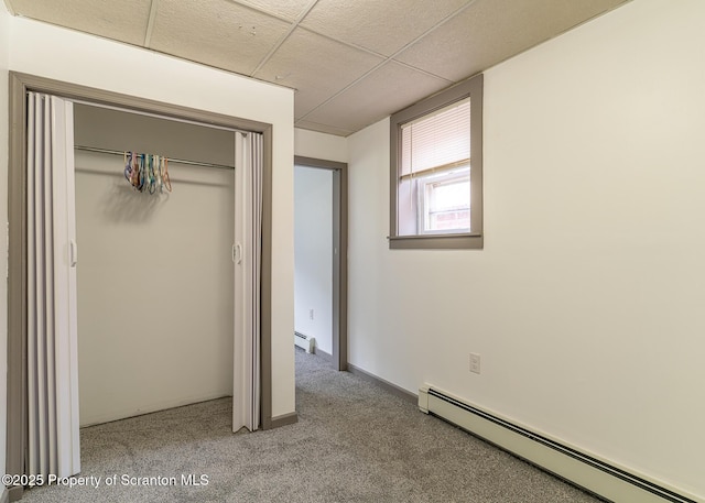 989 Main St, New Milford, PA 18834 - unfurnished bedroom with a baseboard heating unit, a closet, carpet floors, and a paneled ceiling