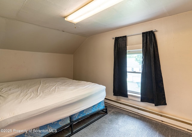 989 Main St, New Milford, PA 18834 - carpeted bedroom featuring a baseboard heating unit and vaulted ceiling