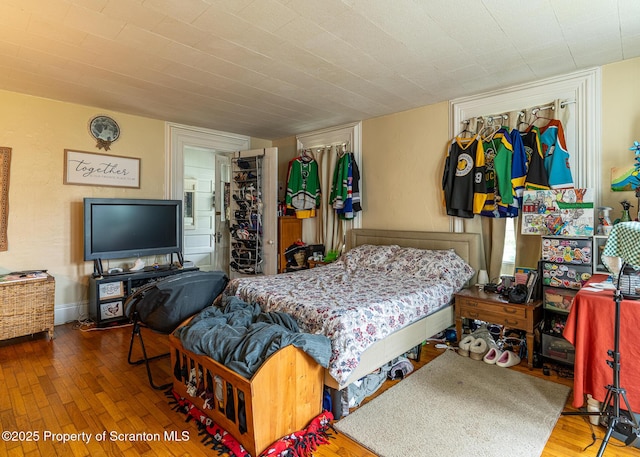 989 Main St, New Milford, PA 18834 - bedroom featuring hardwood / wood-style floors, a closet, and a walk in closet