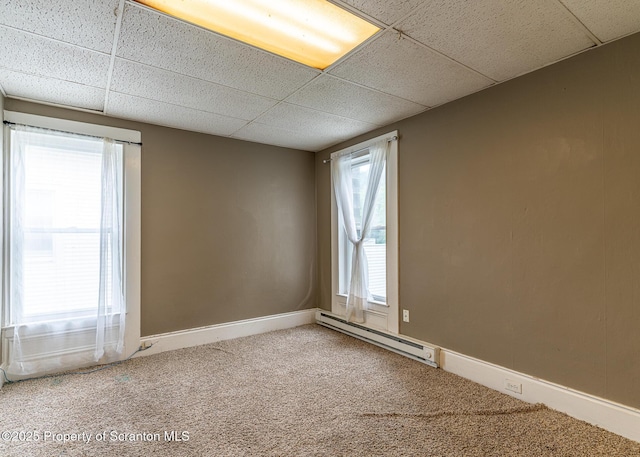989 Main St, New Milford, PA 18834 - carpeted empty room featuring a paneled ceiling and a baseboard heating unit