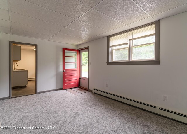 989 Main St, New Milford, PA 18834 - unfurnished bedroom featuring a baseboard radiator, a drop ceiling, carpet flooring, and a baseboard heating unit