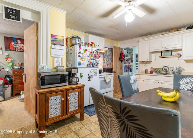989 Main St, New Milford, PA 18834 - kitchen with white appliances, white cabinets, and a ceiling fan