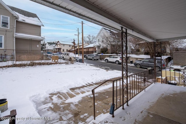 yard layered in snow with a residential view