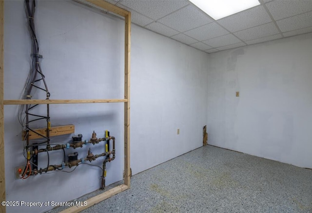 basement with a paneled ceiling