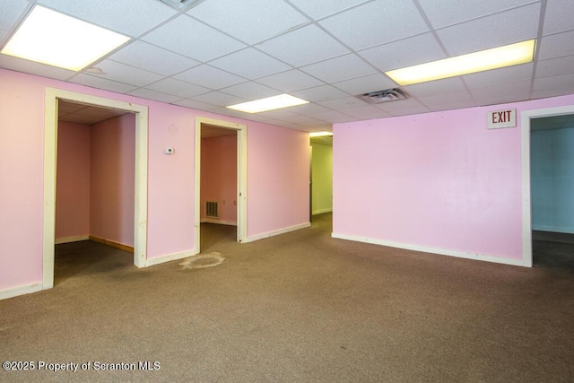 empty room featuring visible vents, baseboards, and carpet