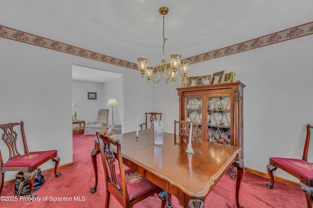 dining room with an inviting chandelier, baseboards, and carpet floors