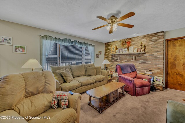 living area with a ceiling fan, carpet, and a textured ceiling