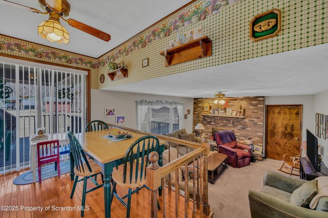 dining space featuring wood-type flooring and ceiling fan