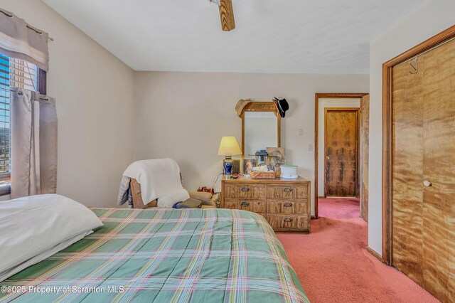 bedroom with baseboards and carpet