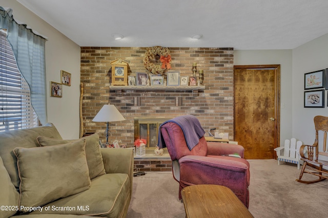 living room with carpet floors, a brick fireplace, and brick wall