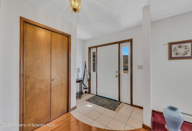 entrance foyer featuring light tile patterned floors and baseboards