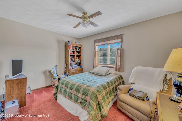 carpeted bedroom with baseboards and a ceiling fan