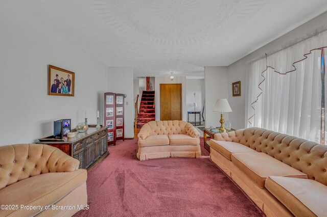 carpeted living area featuring stairway and a textured ceiling