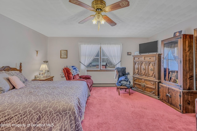 bedroom featuring baseboard heating, a ceiling fan, and carpet floors