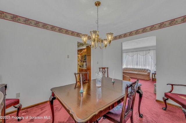 dining space featuring a chandelier, carpet flooring, and baseboards