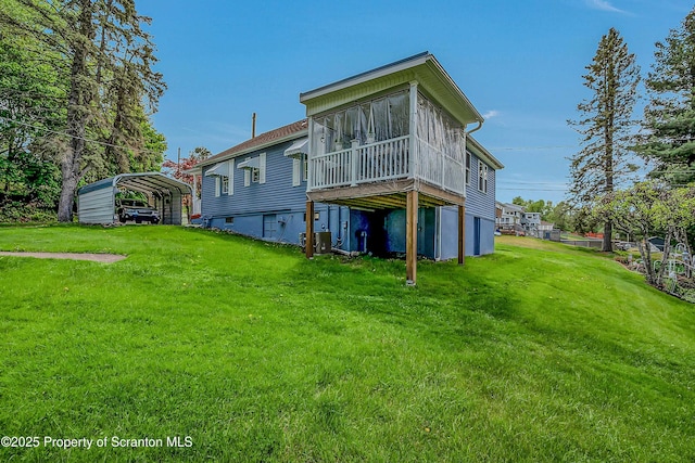 2230 Birney Ave, Scranton, PA 18505 - back of house with a detached carport, a lawn, central AC, and a sunroom