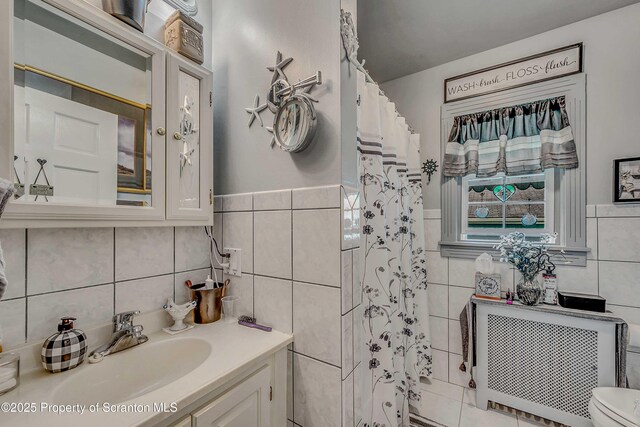 2230 Birney Ave, Scranton, PA 18505 - full bath with tile walls, radiator heating unit, vanity, toilet, and a shower with curtain