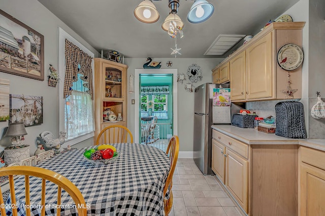 2230 Birney Ave, Scranton, PA 18505 - kitchen with light brown cabinets, light countertops, freestanding refrigerator, and a chandelier