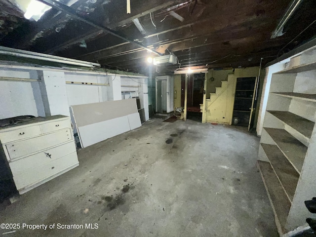 unfinished basement featuring stairs