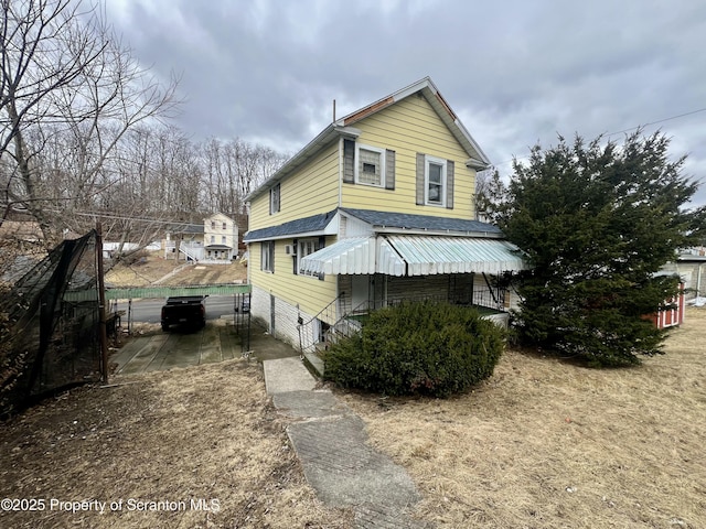 view of home's exterior with a garage and a shingled roof