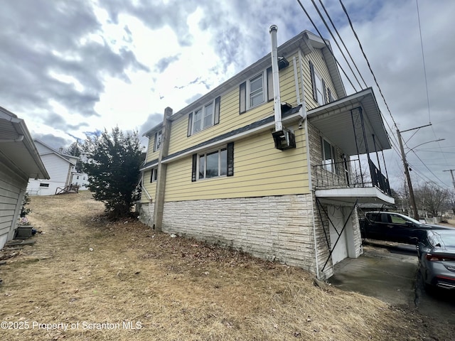 view of home's exterior featuring an attached garage and stone siding