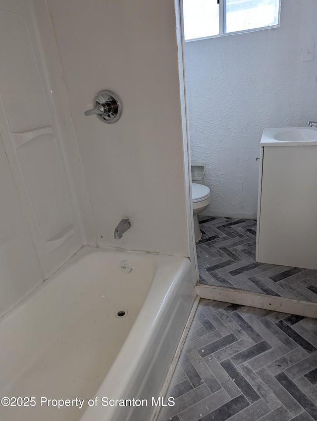 bathroom featuring toilet and vanity